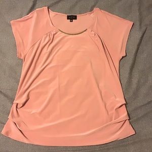 A formal coral colored blouse.